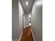 Hallway view features hardwood floors, neutral paint and doorways into various rooms at 2360 Barrington Trace Sw Cir, South Fulton, GA 30331