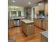 Spacious kitchen with light wood cabinets, granite countertops, stainless appliances, and an island at 2360 Barrington Trace Sw Cir, South Fulton, GA 30331