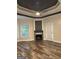 Living room with wood-look floors, gas fireplace, and access to exterior patio at 2360 Barrington Trace Sw Cir, South Fulton, GA 30331