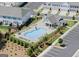 Aerial view of a community pool surrounded by lounge chairs, a clubhouse, and parking at 3349 Verdi Ln, Kennesaw, GA 30144