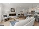 Open-concept living room with a fireplace, comfortable seating, and a view into the kitchen at 3349 Verdi Ln, Kennesaw, GA 30144