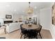 Open-concept dining room, living room, and kitchen with pendant lighting and an electric fireplace at 3349 Verdi Ln, Kennesaw, GA 30144