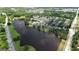 Aerial view showcasing the community with a pond surrounded by homes and lush landscaping at 675 Mallard Cv, Loganville, GA 30052