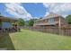 Expansive backyard showcasing lush green grass and a tall wooden fence for added privacy at 675 Mallard Cv, Loganville, GA 30052
