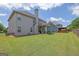 Spacious backyard features a well-maintained lawn and covered patio area, perfect for outdoor gatherings at 675 Mallard Cv, Loganville, GA 30052