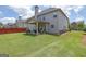 Spacious backyard with a covered patio, a lush lawn perfect for outdoor activities at 675 Mallard Cv, Loganville, GA 30052