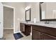 Bathroom featuring a dual-sink vanity with granite countertop, tile flooring, and connecting room at 675 Mallard Cv, Loganville, GA 30052