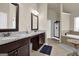 Bathroom featuring a dual-sink vanity with granite countertop, tile flooring, and a separate bathtub and shower at 675 Mallard Cv, Loganville, GA 30052