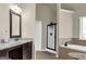 Bathroom featuring a dual-sink vanity with granite countertop, tile flooring, and separate tub and shower at 675 Mallard Cv, Loganville, GA 30052