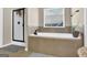 Modern bathroom with a standalone shower and large soaking tub beneath a bright window at 675 Mallard Cv, Loganville, GA 30052