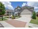 Spacious home with a two-car garage, brick driveway and manicured lawn at 675 Mallard Cv, Loganville, GA 30052