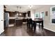 Eat-in kitchen featuring dark wood cabinets, stainless steel appliances, and table with seating at 675 Mallard Cv, Loganville, GA 30052