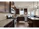 Well-equipped kitchen with stainless steel appliances, granite countertops, and dark wood cabinets at 675 Mallard Cv, Loganville, GA 30052