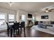 Cozy living room with a stone fireplace, TV, and an adjacent dining area at 675 Mallard Cv, Loganville, GA 30052