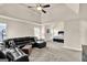 Spacious living room featuring a black leather sectional sofa that leads into the main bedroom at 675 Mallard Cv, Loganville, GA 30052