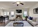 Inviting living room with stone fireplace, comfortable seating, and large windows at 675 Mallard Cv, Loganville, GA 30052