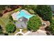Aerial shot of the community pool, surrounded by lush landscaping and lounge chairs at 675 Mallard Cv, Loganville, GA 30052