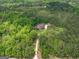 Expansive aerial view showcasing the property, surrounded by lush trees and a long driveway leading to the main house at 210 Short Rd, Sharpsburg, GA 30277
