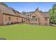 Expansive lawn space behind a brick home with mature trees and manicured lawn at 210 Short Rd, Sharpsburg, GA 30277