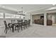 Basement dining area adjacent to living room with a large wooden table and seating for eight at 210 Short Rd, Sharpsburg, GA 30277