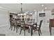 Bright dining area with a large wooden table and decorative chandelier in a finished basement at 210 Short Rd, Sharpsburg, GA 30277