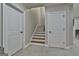 Finished basement area with staircase, featuring carpet flooring and neutral walls at 210 Short Rd, Sharpsburg, GA 30277