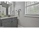 Bathroom featuring grey vanity with granite countertop and natural light from the window at 210 Short Rd, Sharpsburg, GA 30277