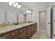 Elegant bathroom featuring a double vanity with granite countertops and modern lighting fixtures at 210 Short Rd, Sharpsburg, GA 30277
