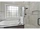 Bright bathroom featuring a standalone tub next to a glass-enclosed walk-in shower at 210 Short Rd, Sharpsburg, GA 30277