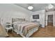 Bright bedroom featuring wood floors, a crystal chandelier, and television at 210 Short Rd, Sharpsburg, GA 30277
