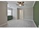 Spacious bedroom with plush carpeting, crown molding and ceiling fan at 210 Short Rd, Sharpsburg, GA 30277
