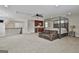 Spacious bedroom featuring a seating area, four poster bed, and a convenient wet bar at 210 Short Rd, Sharpsburg, GA 30277