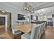 Dining room with hardwood floors and view to the kitchen, featuring an ornate light fixture and seating for ten at 210 Short Rd, Sharpsburg, GA 30277
