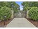 Elegant gated entrance with stone pillars, securing the property and adding to its secluded charm at 210 Short Rd, Sharpsburg, GA 30277
