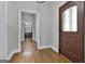 Entryway with hardwood floors and a decorative wood door and light fixture at 210 Short Rd, Sharpsburg, GA 30277
