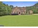 Beautiful brick home with a sprawling green lawn and mature trees, offering a picturesque and inviting setting at 210 Short Rd, Sharpsburg, GA 30277