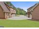Three-car garages with attached apartments, showcasing ample parking and green lawn at 210 Short Rd, Sharpsburg, GA 30277