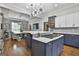 Bright, modern kitchen with a spacious island, gas cooktop, and seamless flow to the dining area at 210 Short Rd, Sharpsburg, GA 30277