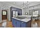 Open-concept kitchen with a gas cooktop, blue cabinets, and a view into the dining area at 210 Short Rd, Sharpsburg, GA 30277