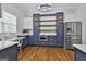 Kitchen with stainless steel refrigerator and custom built-in blue cabinets and shelving at 210 Short Rd, Sharpsburg, GA 30277