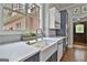 Modern kitchen with blue cabinets, a farmhouse sink under the window, and stainless steel appliances at 210 Short Rd, Sharpsburg, GA 30277