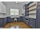 Spacious kitchen with white countertops, blue custom cabinetry, and a corner desk at 210 Short Rd, Sharpsburg, GA 30277