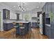 Spacious kitchen featuring an island with breakfast bar, modern lighting, and blue and white cabinetry at 210 Short Rd, Sharpsburg, GA 30277