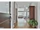 Bright and airy living room with hardwood floors, neutral decor, and large windows offering views of the surrounding greenery at 210 Short Rd, Sharpsburg, GA 30277