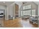 Living room with stone fireplace, hardwood floors, large windows, and vaulted ceiling at 210 Short Rd, Sharpsburg, GA 30277