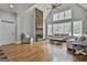 Bright living room featuring a stone fireplace, hardwood floors, vaulted ceilings, and lots of windows at 210 Short Rd, Sharpsburg, GA 30277