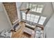 Inviting living room featuring a floor-to-ceiling stone fireplace and soaring windows at 210 Short Rd, Sharpsburg, GA 30277