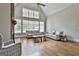 Bright living room featuring a stone fireplace, hardwood floors, and vaulted ceilings with lots of windows at 210 Short Rd, Sharpsburg, GA 30277