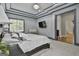 Spacious main bedroom with tray ceilings, a TV, and a window for natural light at 210 Short Rd, Sharpsburg, GA 30277