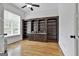 Office space featuring hardwood floors, a ceiling fan, and custom cabinets with a granite countertop at 210 Short Rd, Sharpsburg, GA 30277